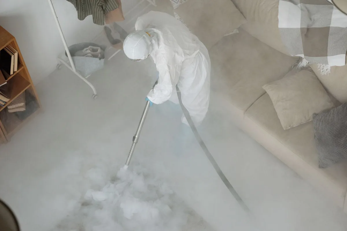 Biohazard cleanup technician in protective equipment, Owensville, MO